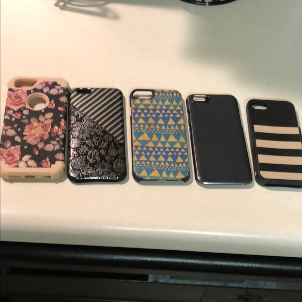 Assorted phone cases for iPhone 6/6s and one 5s.